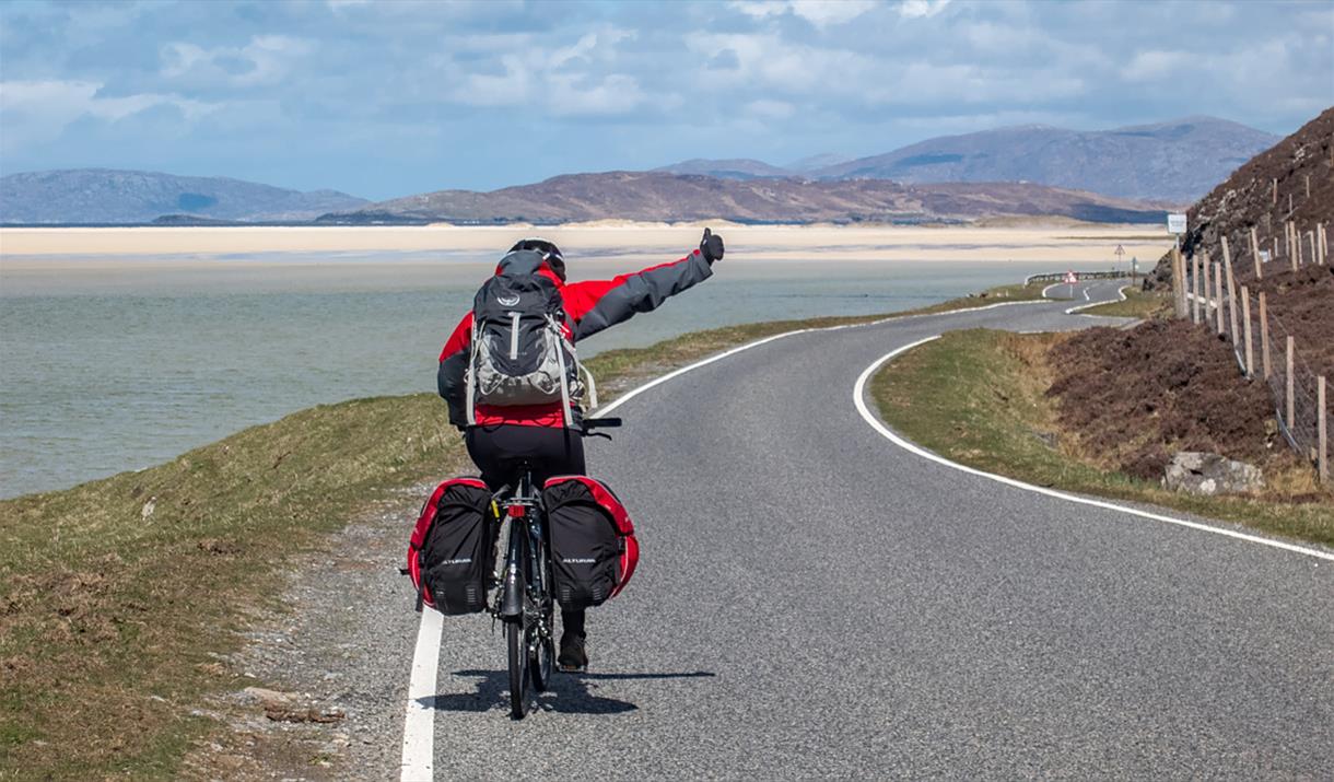 Ticket To Ride cyclist on the road and beach