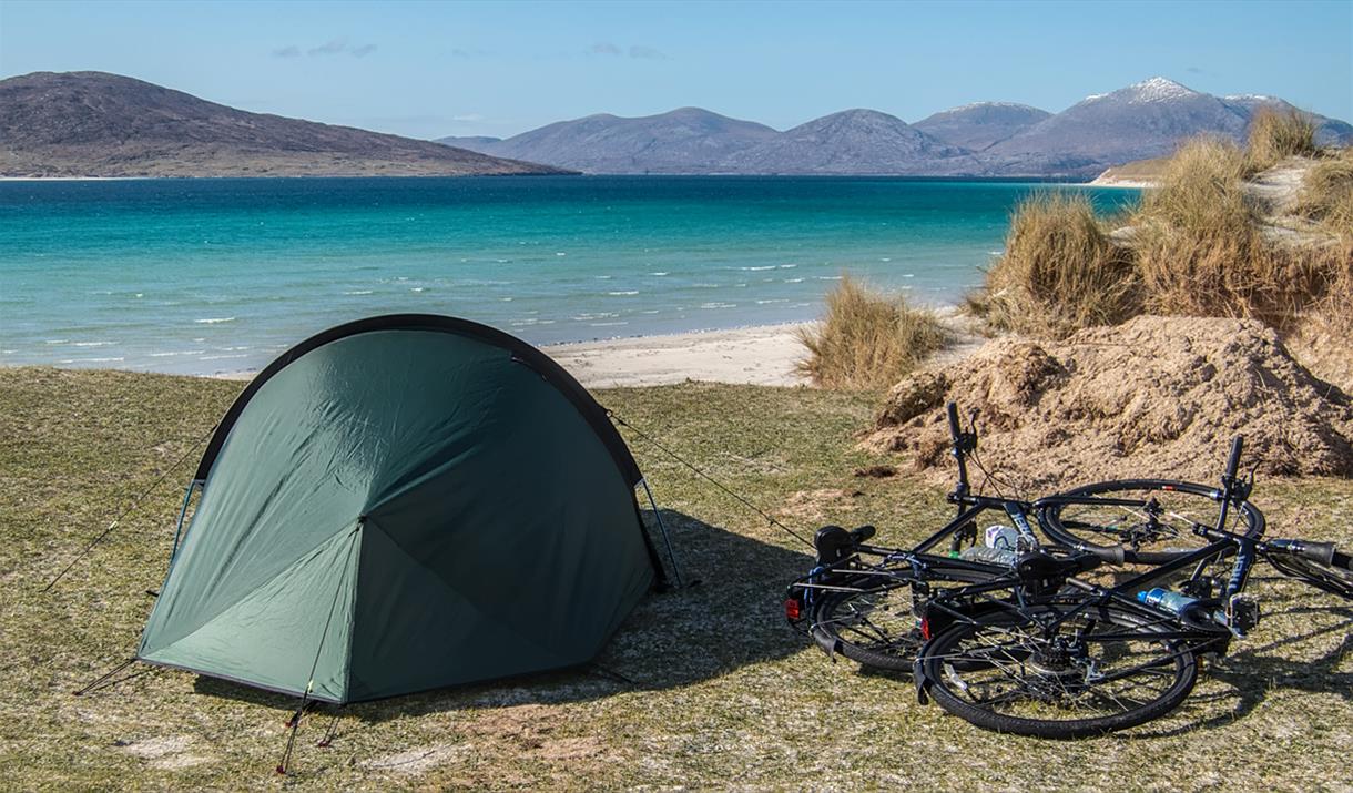 Ticket To Ride bike and tent at beach