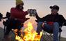 Heb360 Tours couple sitting at camp fire