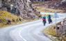 Harris: cyclists on winding double track road
