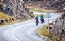 Harris: cyclists on winding double track road