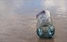 Eat Drink Hebrides - Isle of Barra Distillery gin bottle on the beach