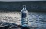 Eat Drink Hebrides - Isle of Barra Distillery gin bottle in sea