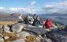 Hidden Hebrides group of people sitting on top of a mountain