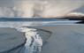 Luskentyre Beach, Isle of Harris, with winter snowfall sweeping from huge Atlantic skies and soft light over the Outer Hebrides coastline Lewis and Ha