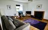 Macleod Cottage Sitting Room, with a view of the log burning stove.