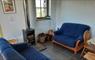 John's Bunkhouse lounge with blue sofas & fire