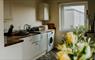 Uist Travel Accommodation kitchen & yellow flowers