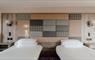 Twin room at the Cabarfeidh Hotel with two beds, headboard in tweed and check and soft colour palette.