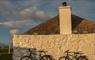 Ticket To Ride white cottage with bikes