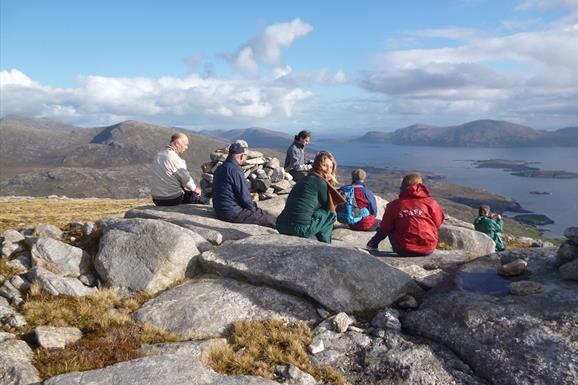 Hidden Hebrides group of people sitting on top of a mountain