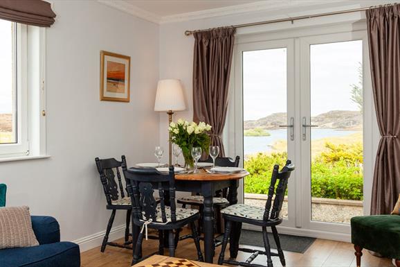 Grey Goose Cottage dining area with a view of the loch