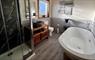 Bathroom with full shower, free standing bath and stone basin