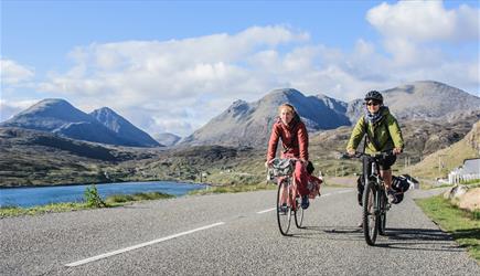 Harris: cyclists at Ardhasaig with Clisham backdrop