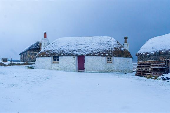 Thatched cottage in the snow